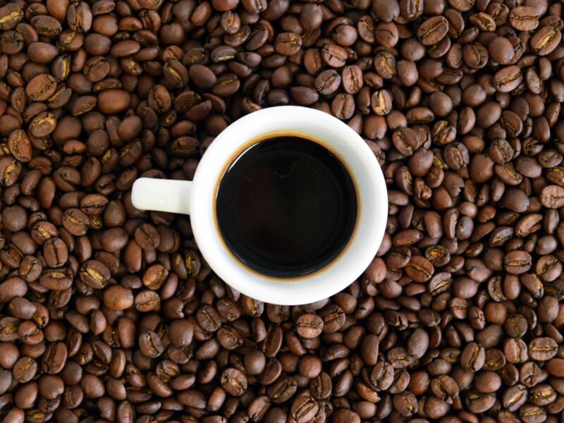 coffee beans and a cup of black coffee