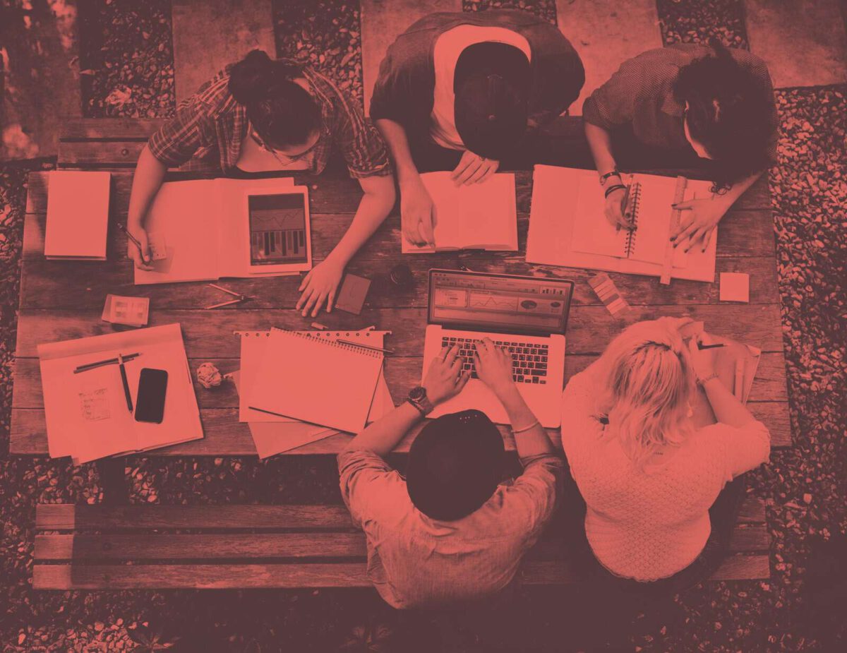 Group of students work on a bench from above