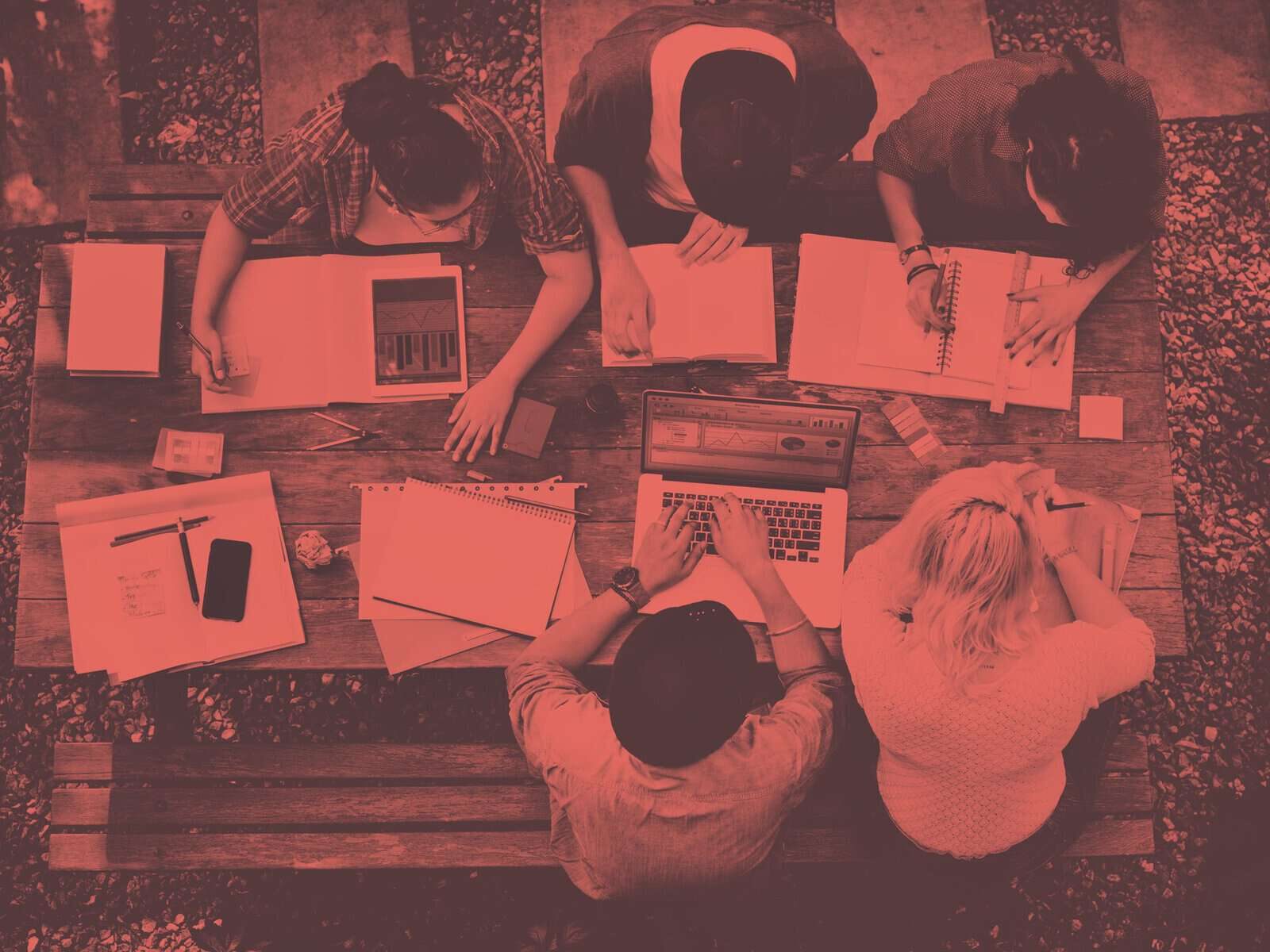 Group of students work on a bench from above