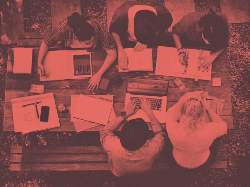 Group of students work on a bench from above