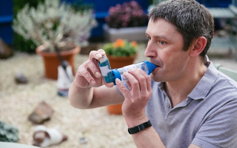 Man using an inhaler