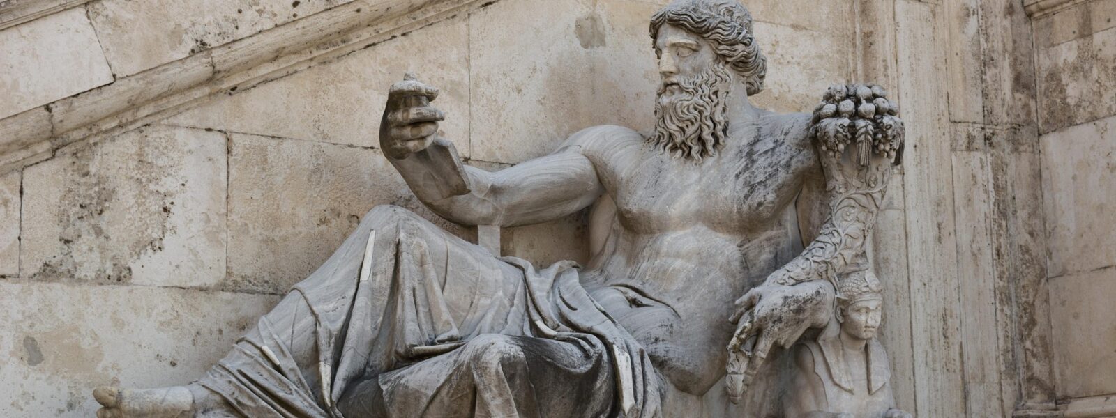 Greek god sculpture in white stone