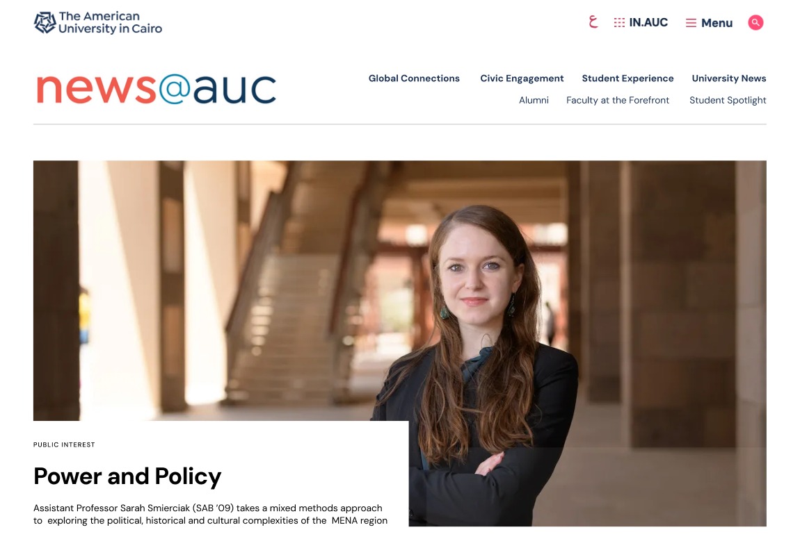 Screenshot from the AUC news page containing an image of a woman dressed in dark clothes who is looking at the camera