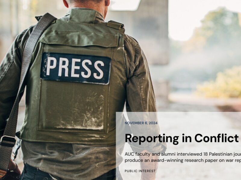 Screenshot from AUC news article showing a member of the press wearing body armour