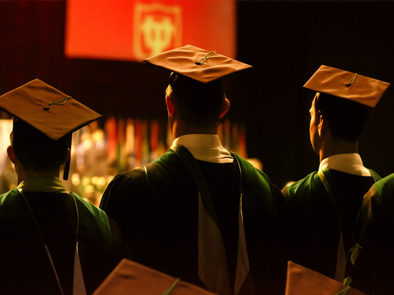 A group of graduates watch a presentation